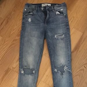 distressed blue light washed jeans from garage